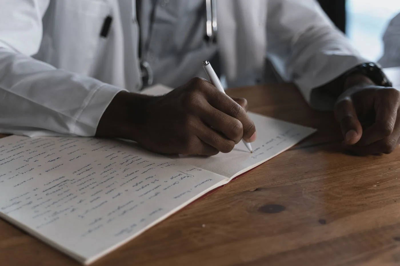 A doctor writing medical notes - the kind of demonstrable expertise Google’s E-E-A-T guidelines reward